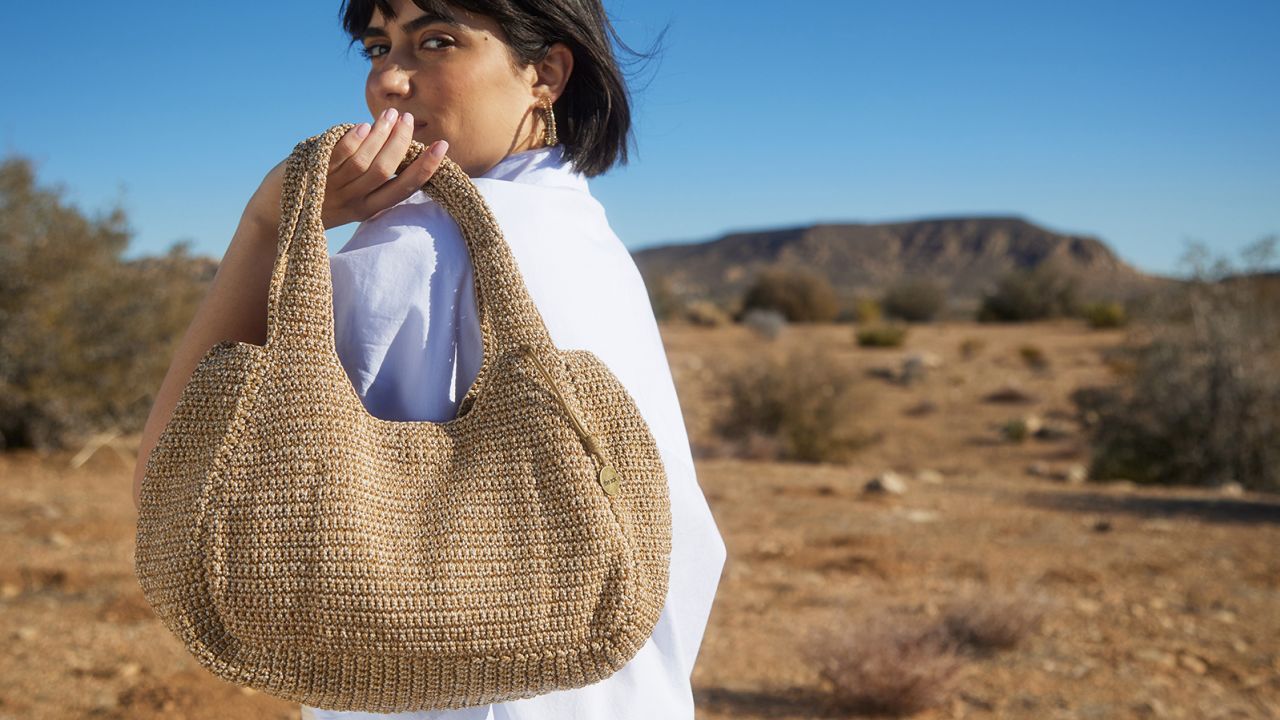 Person holding a purse from The Sak.