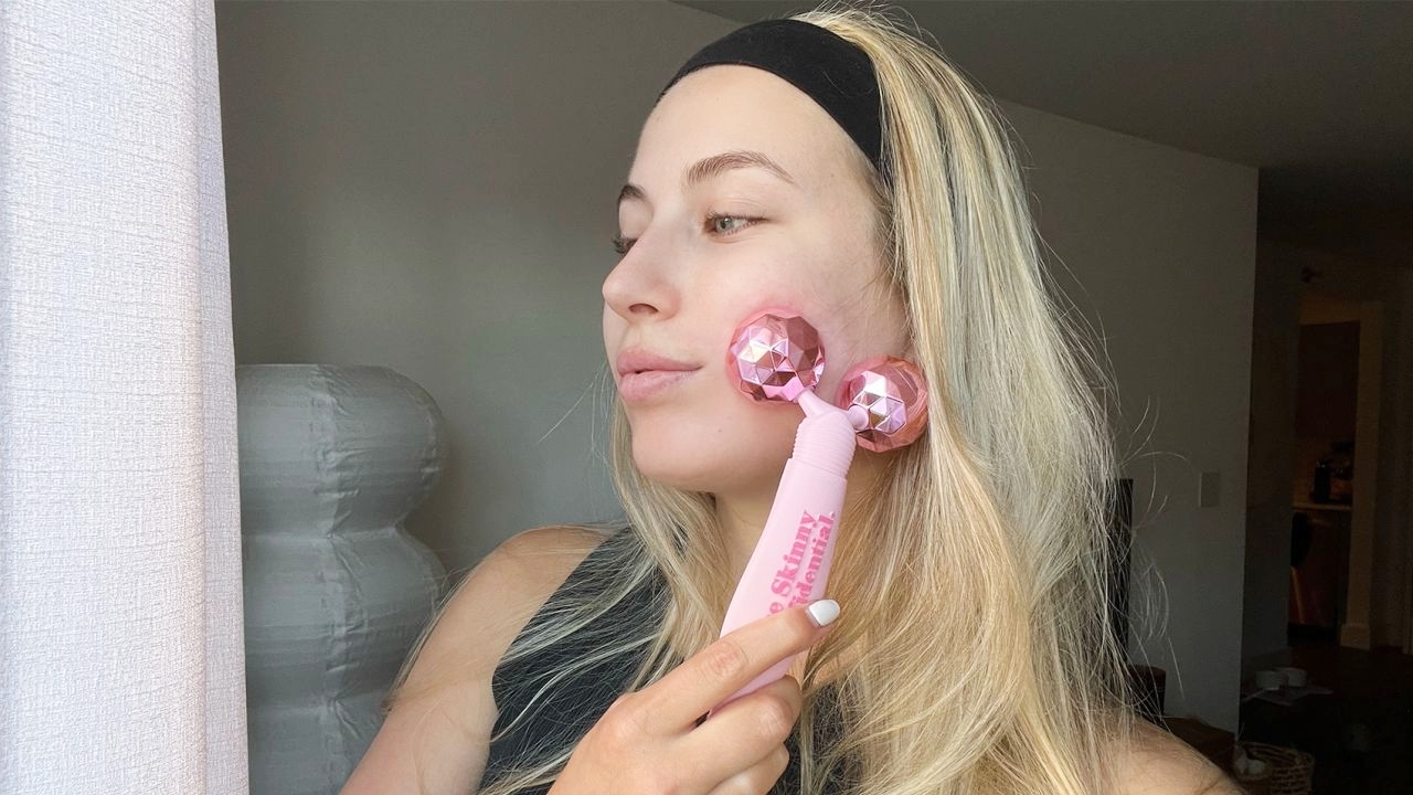 Person using The Skinny Confidential Pink Balls Face Massager Person using The Skinny Confidential Pink Balls Face Massager