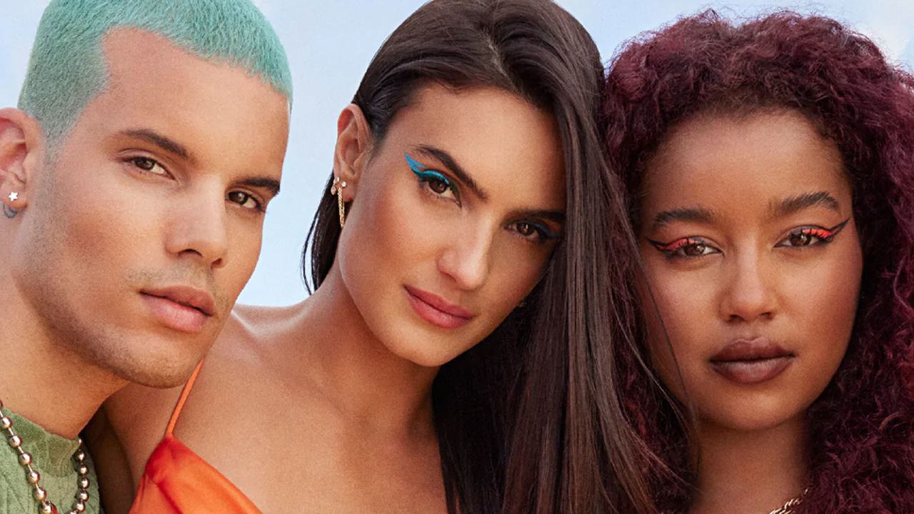 Trio of people wearing bright makeup