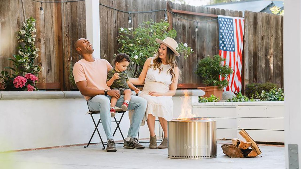 Family sitting around a Solo Stove Family sitting around a Solo Stove
