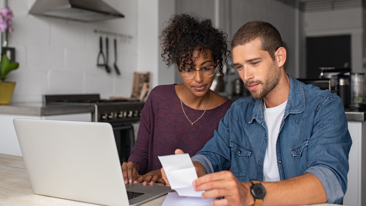 Couple examining documents together.