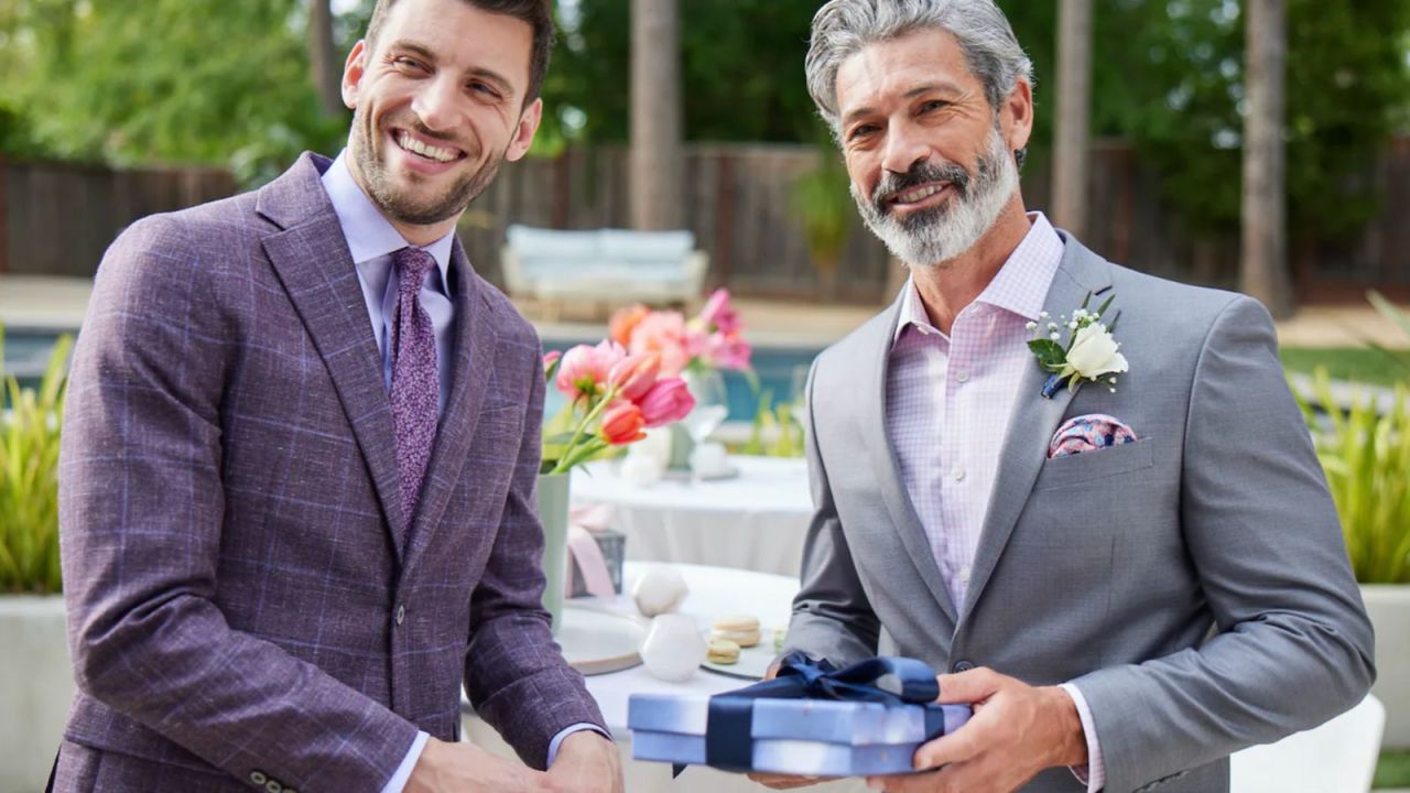Two people wearing Men's Wearhouse suits
